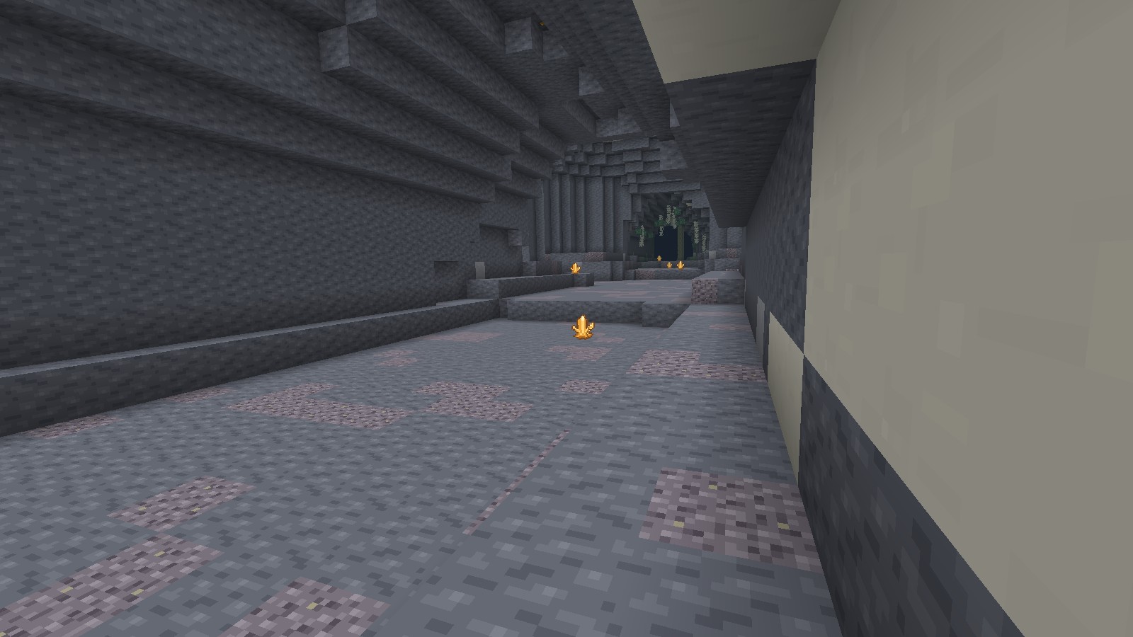 Amber clusters light an enclosed stone passage beneath hanging pale roots in the Ravel